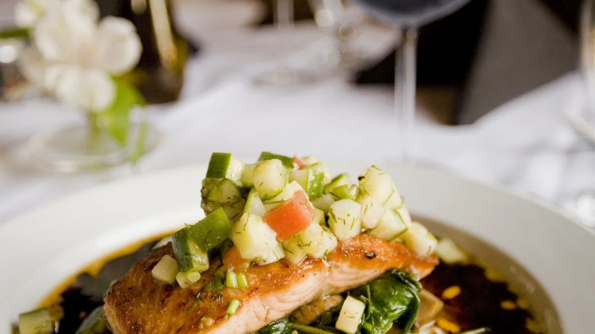 Overhead view of a balanced Mediterranean meal with salmon quinoa and fresh vegetables for menopause diet plan
