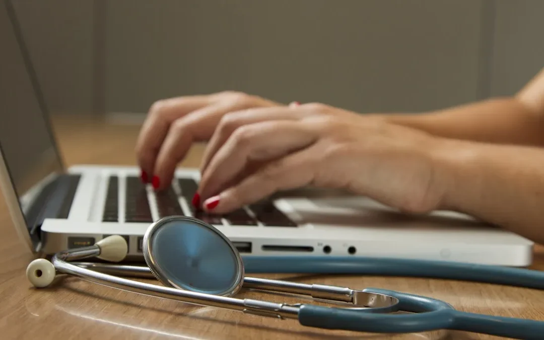 Signs you need hormone replacement therapy - healthcare professional with stethoscope at laptop