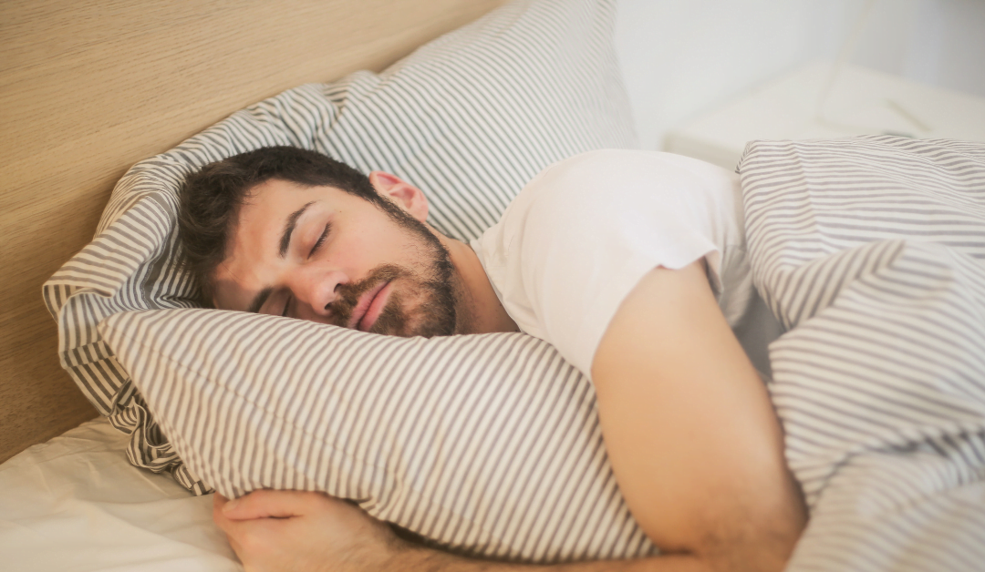 muscular man sleeping in modern bedroom