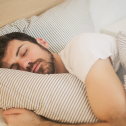 muscular man sleeping in modern bedroom