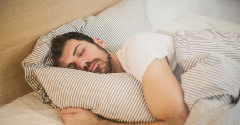 muscular man sleeping in modern bedroom