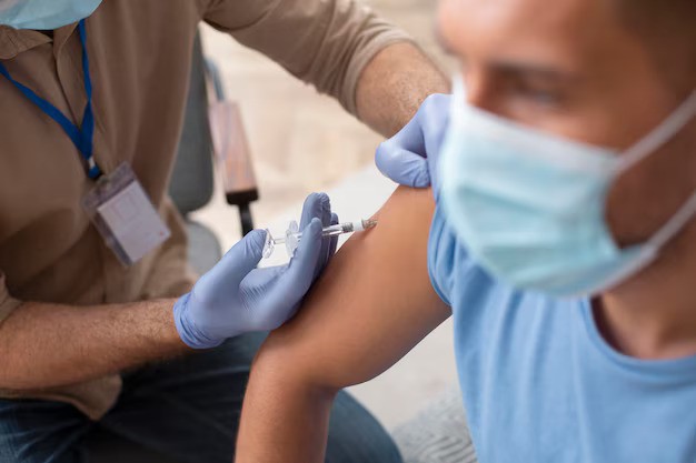 close-up-man-getting-vaccinated_23-2149046136