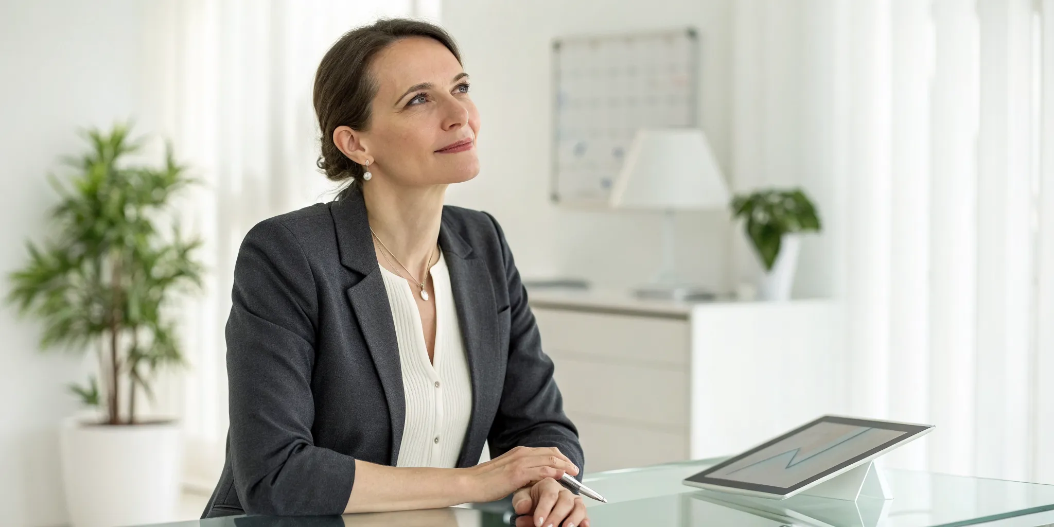 A thoughtful woman at her desk researching androgen deficiency in women.