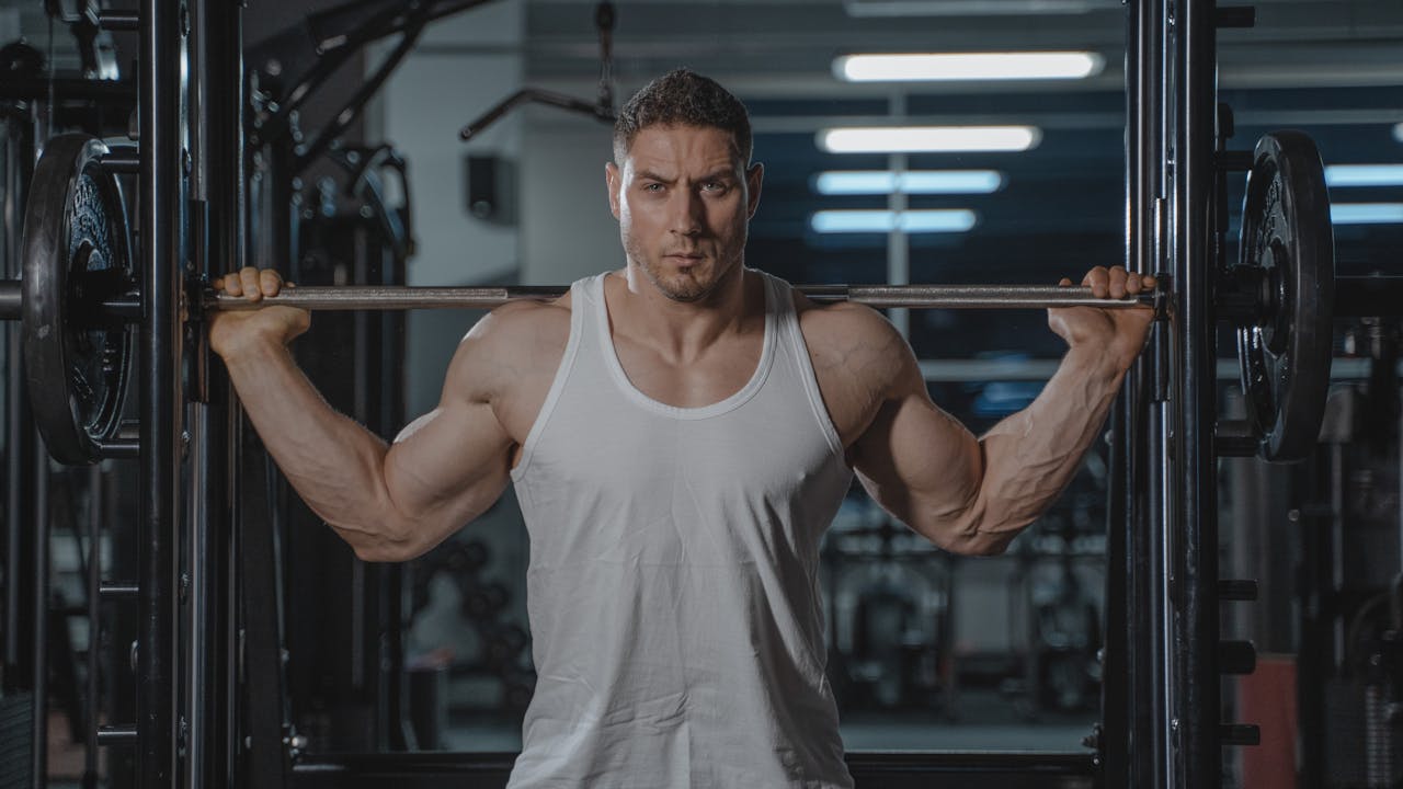 Person performing dumbbell exercises to preserve muscle while on GLP-1 weight loss medication
